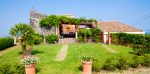 Le Case Di Civi - photo d'une des maison avec une grande terrasse ombragée et devant une grande pelouse verte