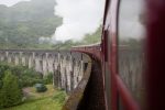 harry potter's famous red steam train on the aqueduct