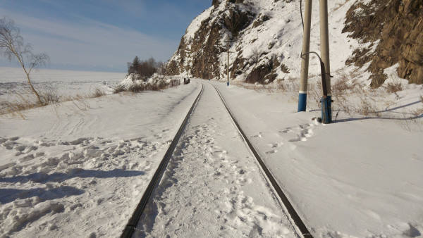 Rails covered with snow and running along the baikal lake
