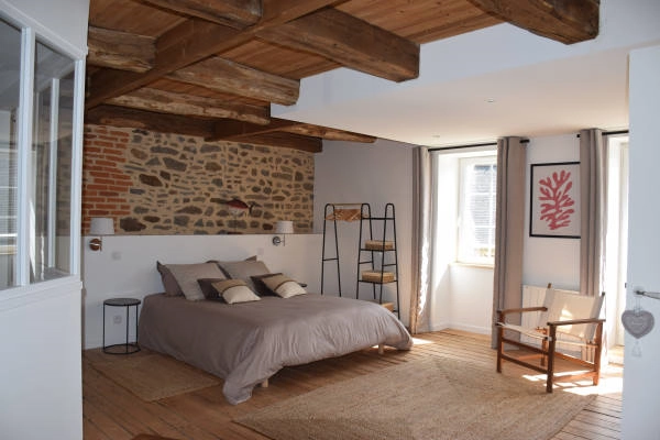 Room with stone wall and exposed beams